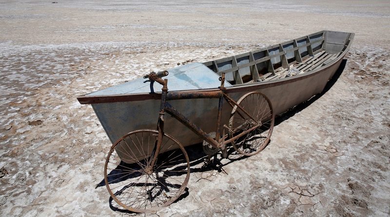 Un bote y una bicicleta en el lago Poopo seco, Oruro (Bolivia), el 16 de diciembre de 2017. (David Mercado / Reuters)